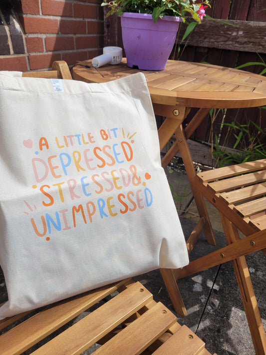 Depressed, stressed and unimpressed tote bag
